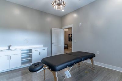 Massage therapy room with treatment table