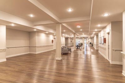 Bright, spacious interior hallway of a senior living facility
