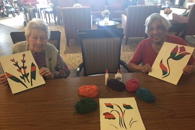 Two residents creating art during an activity session