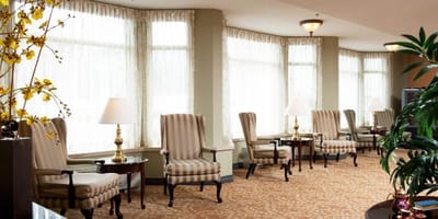 Bright lounge area with comfortable seating and large windows