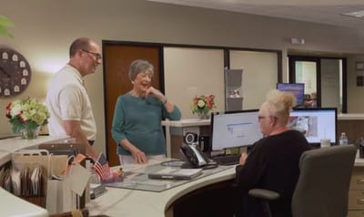 Staff and residents interacting at the reception desk