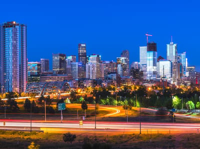 City skyline at dusk with illuminated buildings