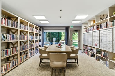 Bright common area with bookshelves and reading table