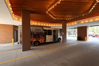 Facility shuttle bus under the porte-cochère