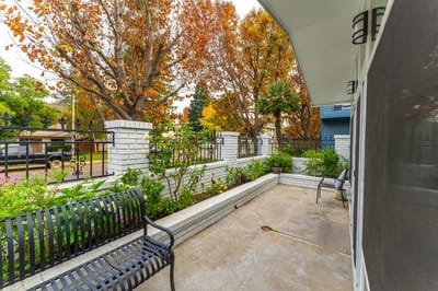 A cozy outdoor patio with benches and plants