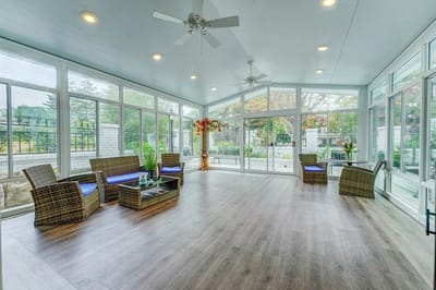 Bright and airy sunroom with seating and plants