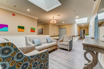 Bright common area with seating and artwork on the walls