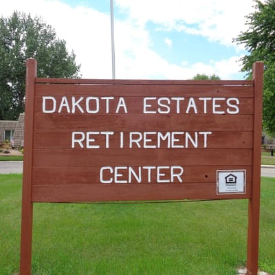 Sign for Dakota Estates Retirement Center in a green area