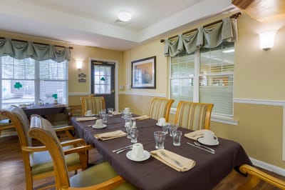 Dining room setup with table settings.