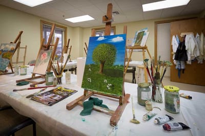 Art supplies and paintings in a creative space