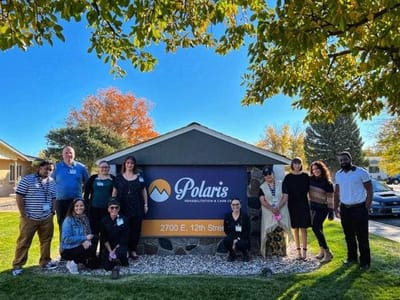 Group photo of staff in front of Polaris Rehabilitation and Care Center sign