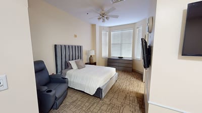 Private resident room with a bed and chair