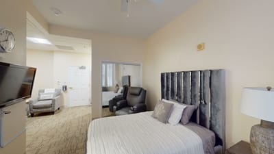 Cozy resident room with a bed and chairs