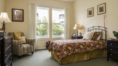 Cozy resident room with a bed and chair