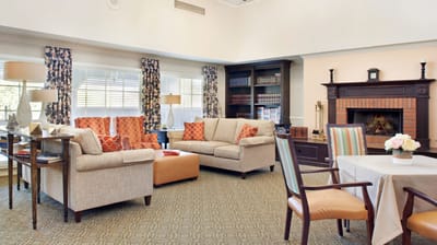 Bright common area with comfortable seating and a fireplace