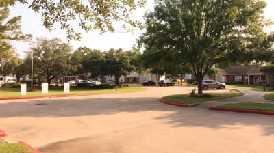 Outdoor view of the facility with trees and parking