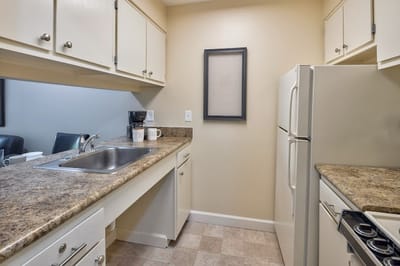 A well-furnished kitchen area in a senior living unit