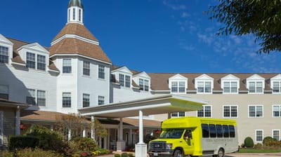 Exterior view of Atria Aquidneck Place with shuttle bus