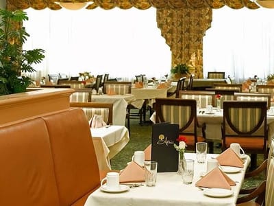 Dining room with neatly arranged tables and place settings
