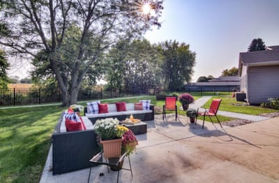 Outdoor seating area with flowers and cushions