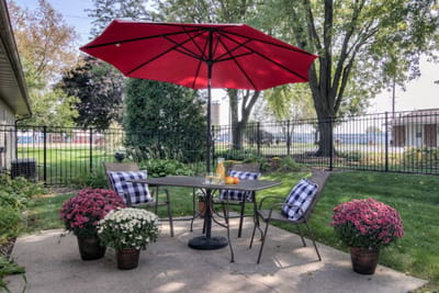 Outdoor seating area with flowers and an umbrella