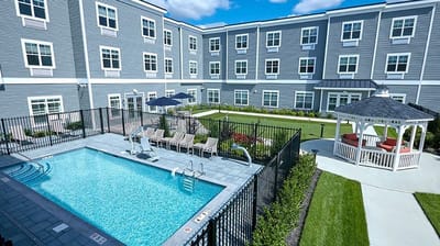 View of an outdoor pool area with seating and gazebo