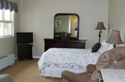 Cozy resident room with a bed and furniture