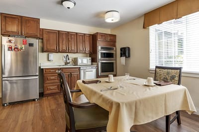 Cozy dining area with set table in an assisted living facility