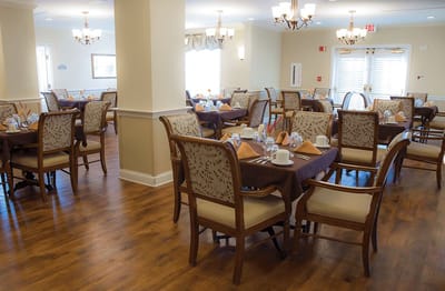 Bright dining room with tables set for meals