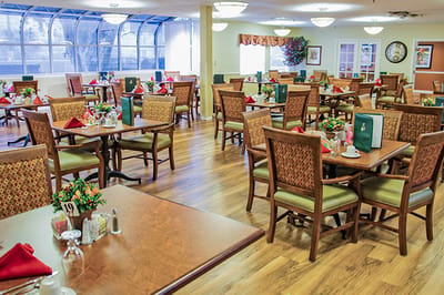 Brightly lit dining room with tables set for a meal