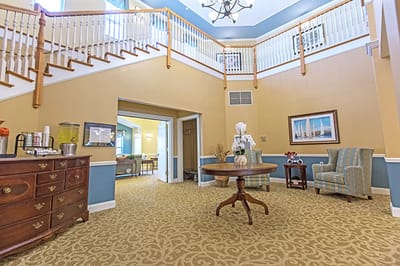 Lobby area with seats and decor in a senior living facility