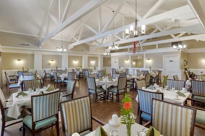 Dining room with tables set for meals and bright decor