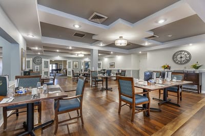Dining room set up for residents with tables and chairs