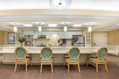 A dining area with chairs and decorative flowers