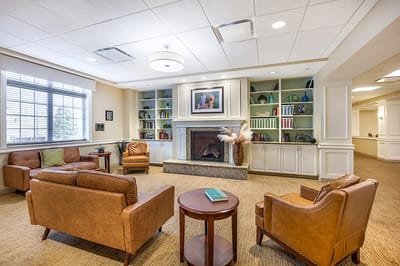 Cozy common area with seating and bookshelf