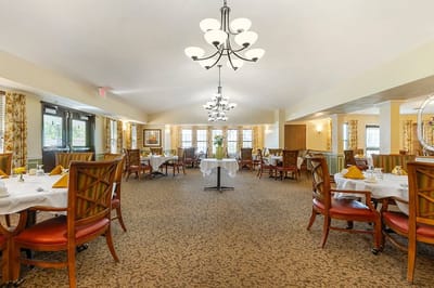 Bright dining room with tables set for meals
