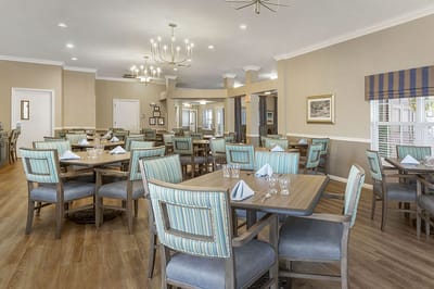 Dining room with elegantly set tables in a common area