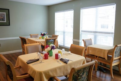 Dining area with tables set for residents