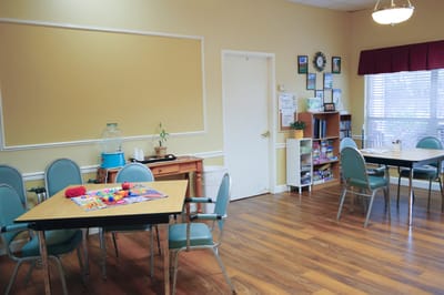 Bright common area with tables and chairs