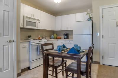 Cozy kitchen area with dining table and appliances