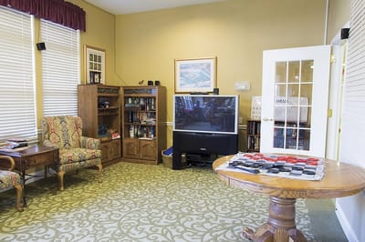 Cozy common area with comfortable seating and bookshelves