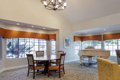 Bright common area with piano and seating