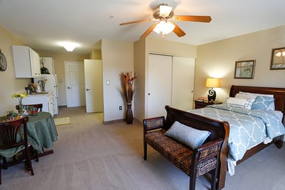 Cozy private resident room with bed and seating area