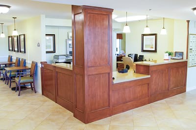 Reception area with wooden counter and chairs