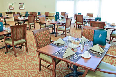 Dining room setup with tables and utensils