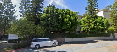 Exterior view of Brookdale Nohl Ranch with landscaping and vehicle