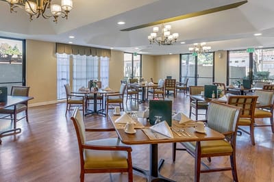 Bright dining room with tables set for a meal