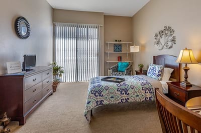 Cozy resident room with a bed and seating area