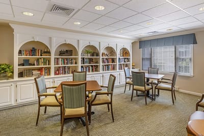 Bright common area with bookshelves and seating.