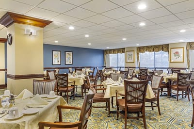 Interior view of a spacious dining room with tables and chairs